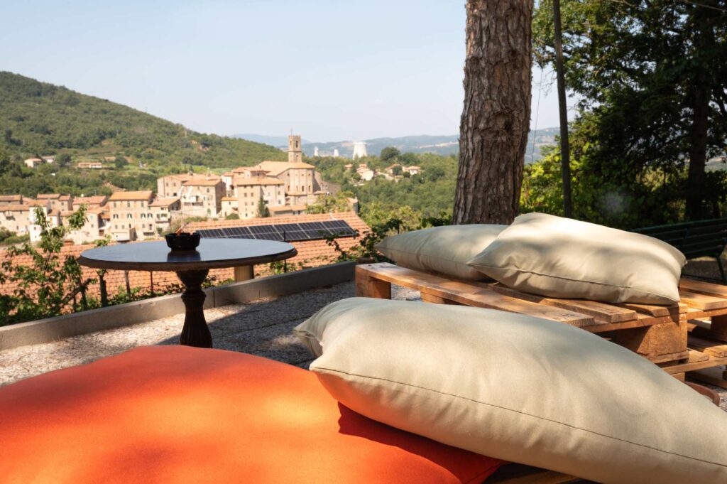 L'area esterna dello Chalet il Madonnino a Sasso Pisano, con tavoli immersi nel verde e ampi spazi per eventi e cene all'aperto
